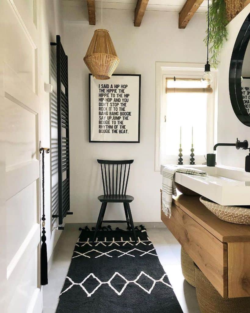 Contemporary bathroom with black and white rug, wooden accents, and hip hop lyric wall art.