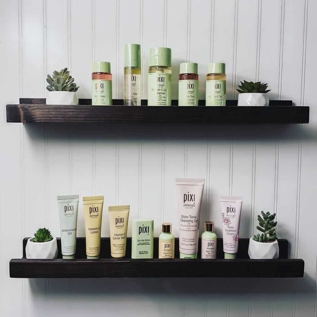 black bathroom wall shelves holding toiletries
