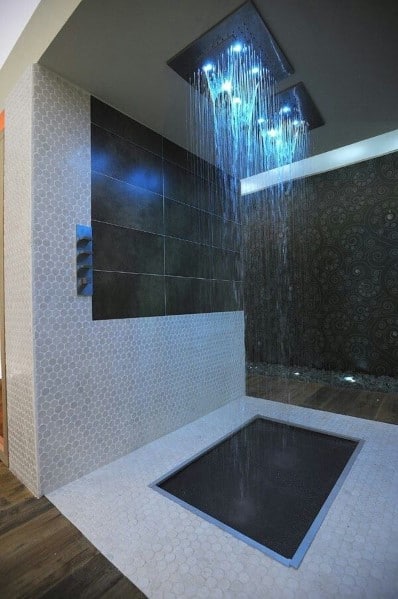Modern shower with rainfall showerhead and blue LED lights in contemporary bathroom