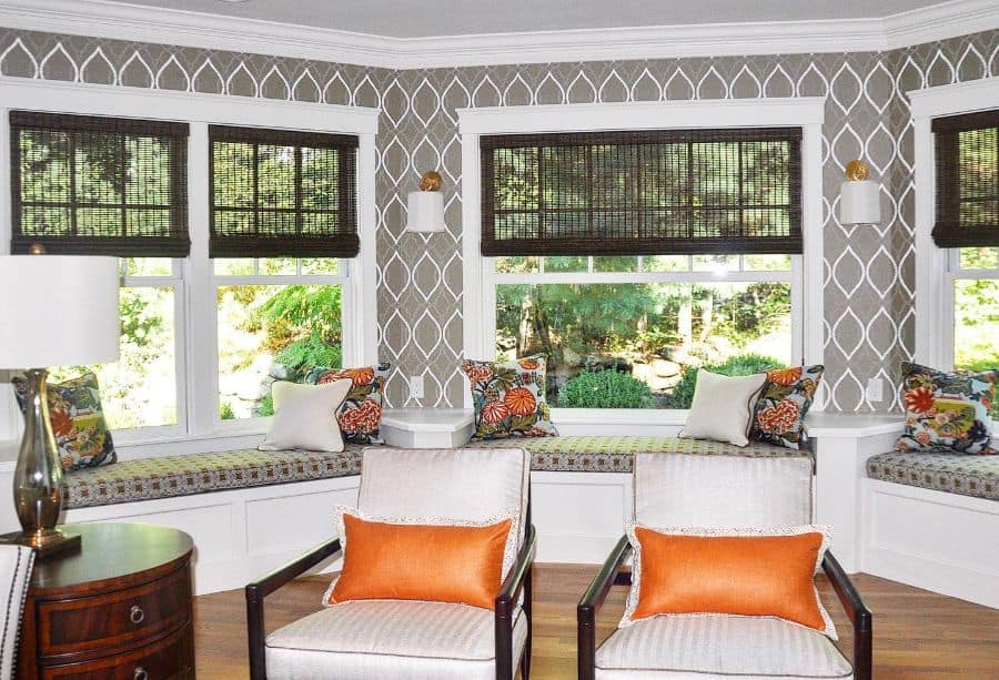 large curved bay window seat two chairs with orange pillows