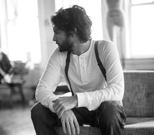 Wavy medium-length hair and a beard