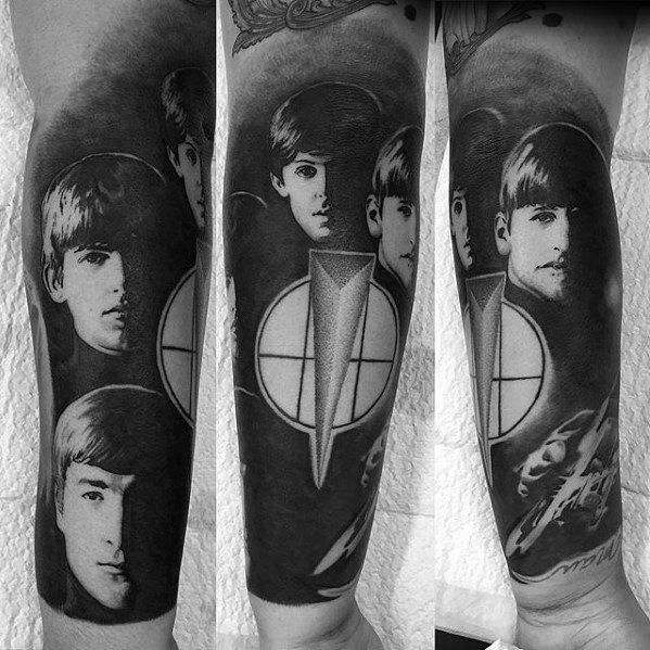 Realistic black and gray Beatles tattoo sleeve featuring detailed portraits of the band members and symbolic geometric elements.