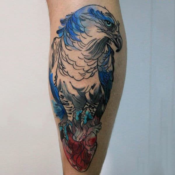 Beautiful Blue Ink Hawk Clutches Heart Tattoo For Gentlemen