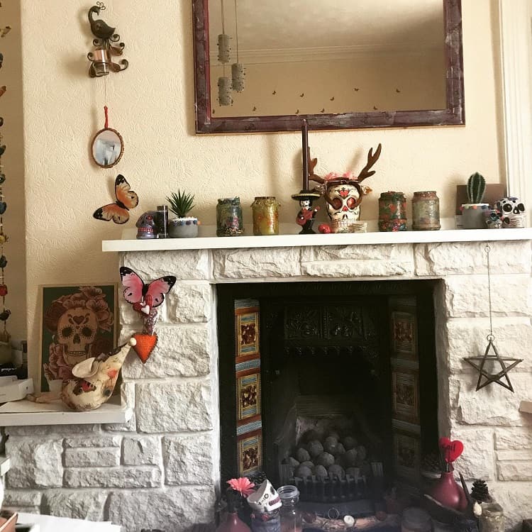 white stone fireplace with candles on mantle