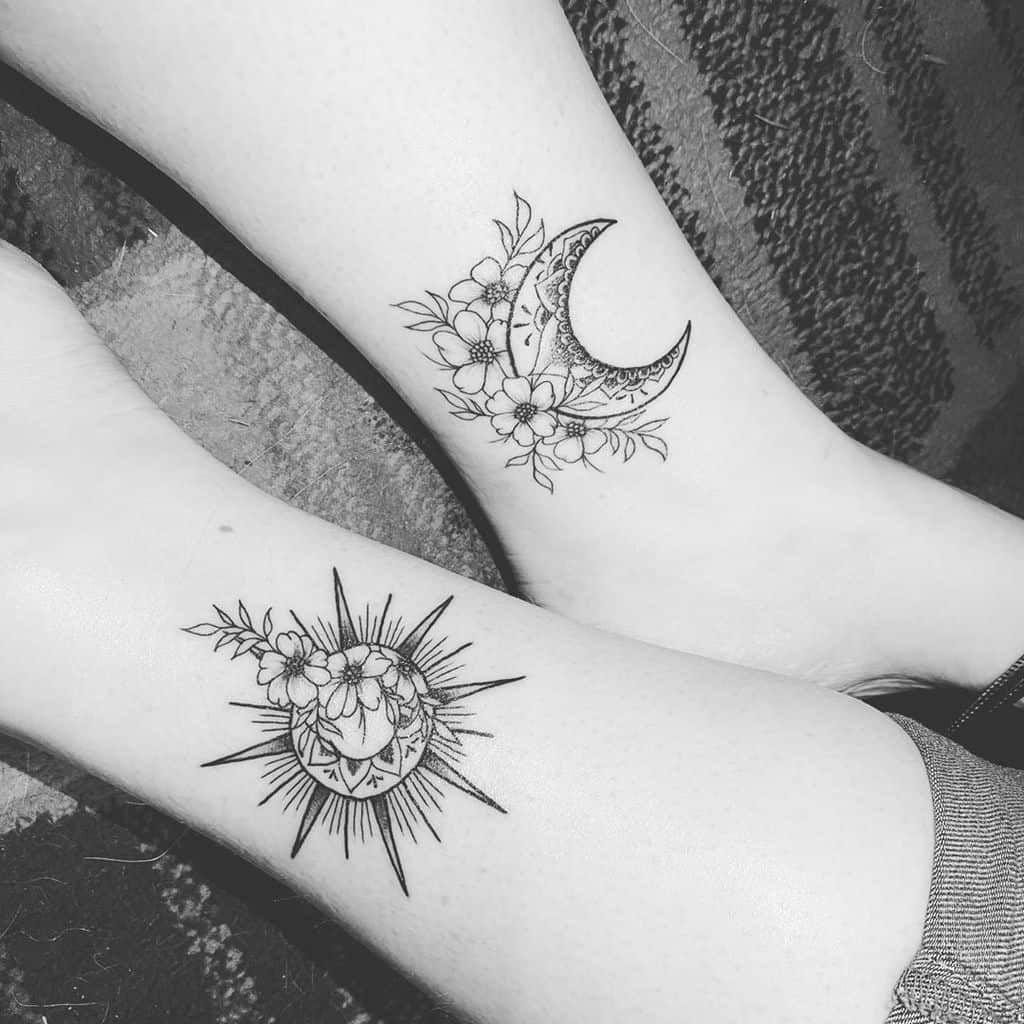 Matching tattoos featuring a floral crescent moon on one leg and a floral sun with rays on the other, symbolizing balance