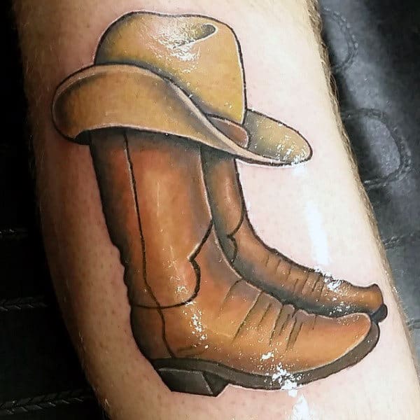 Beautiful Shaded Illustrative Realistic Tattoo For Guys With Cowboy Boots And Hat