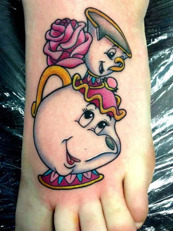 Vibrant tattoo of Mrs. Potts and Chip from Beauty and the Beast, featuring bold outlines, bright colors, and a pink rose accent.