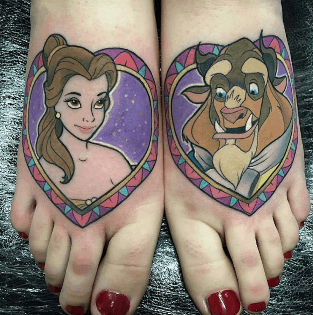 Matching Beauty and the Beast tattoos on feet, featuring Belle and the Beast in heart-shaped frames with a colorful geometric border.