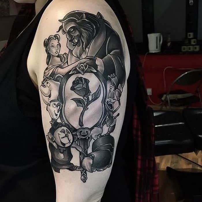 Black and grey tattoo sleeve featuring Belle and the Beast, the enchanted rose in a mirror, and supporting characters like Lumière, Cogsworth, and Mrs. Potts.