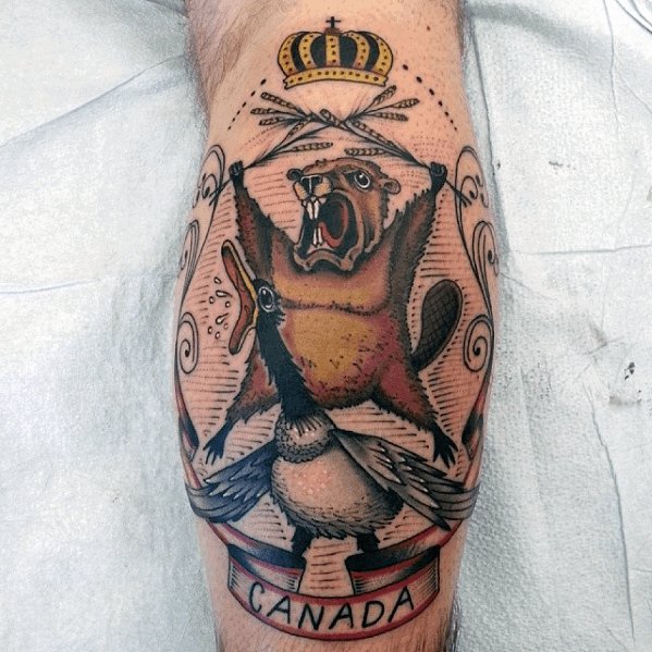 Bold beaver and goose tattoo with crossed hockey sticks, crown, and “Canada” banner in a crest-style patriotic design.