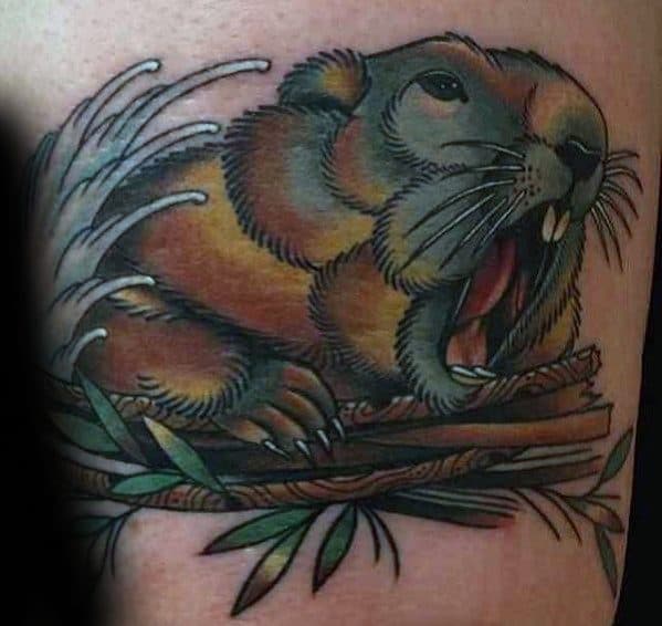 Yawning beaver tattoo resting on a branch pile with splashing water and lush green leaves in a bold, colorful style.