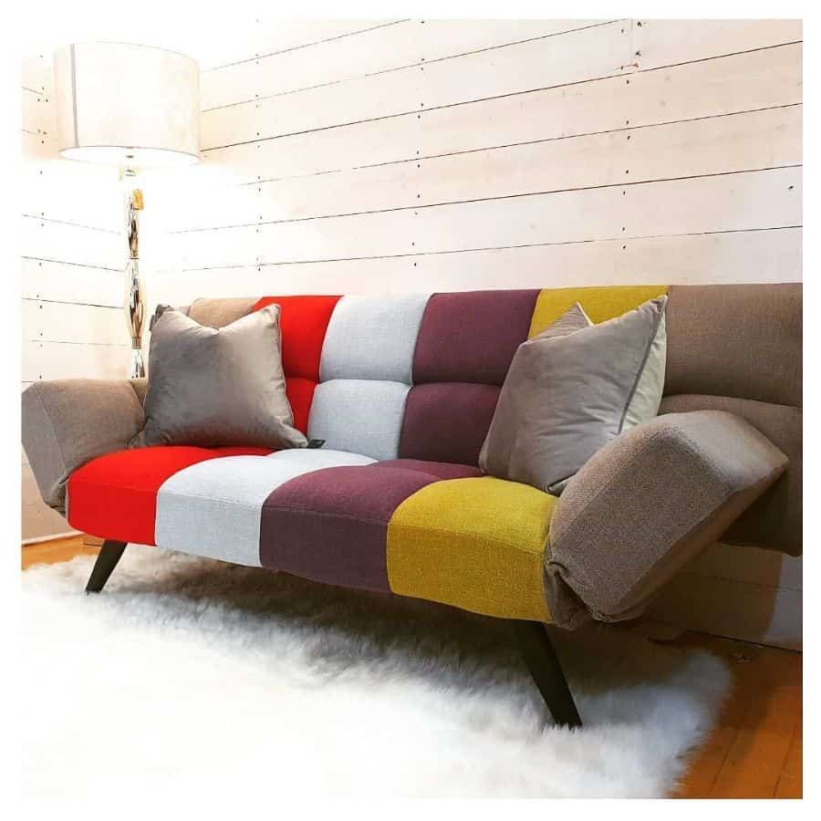 colorful sofa in white shiplap living room fluffy floor rug