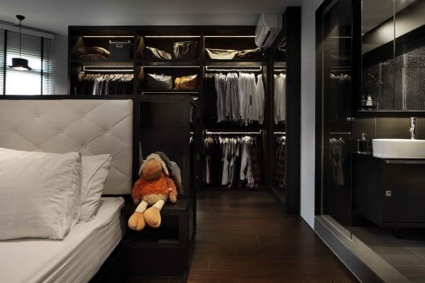 Bedroom with stuffed animal on the bed and an open walk-in closet in the background