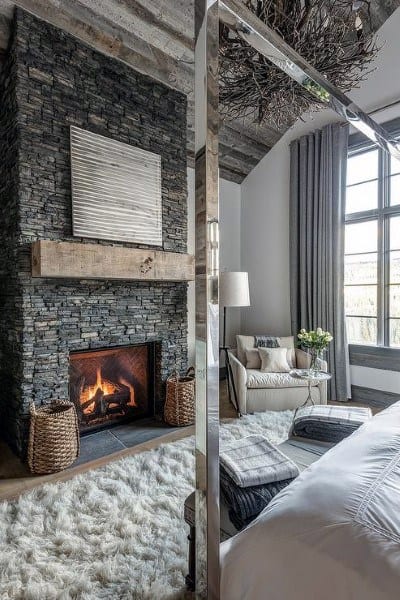stone fireplace in rustic bedroom