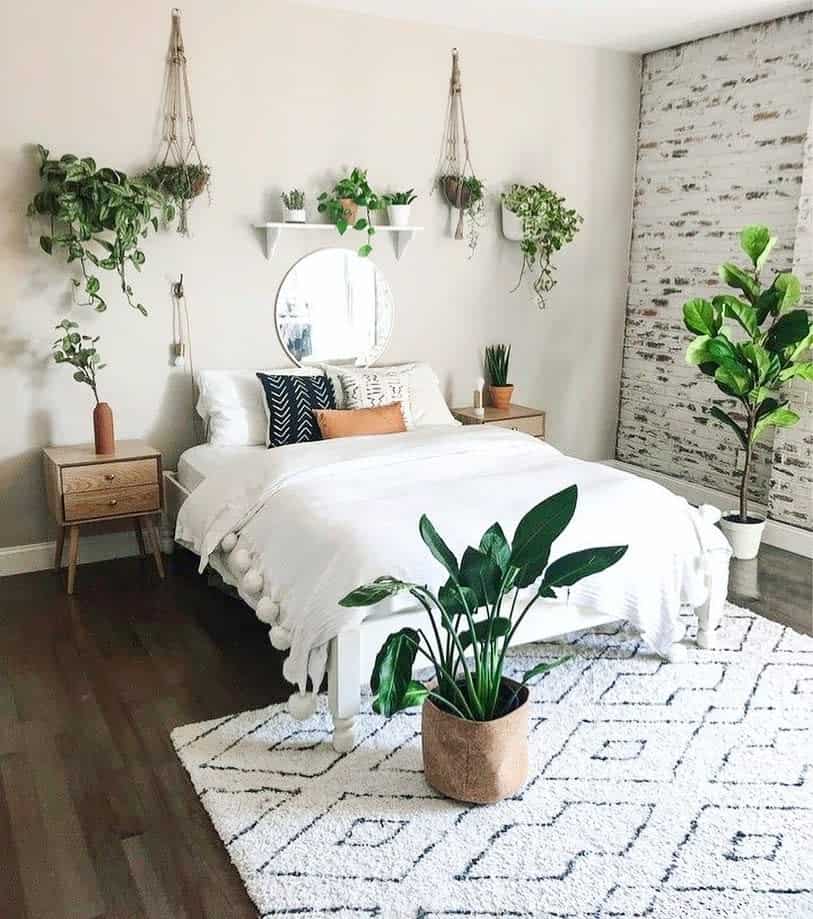 minimalistic boho bedroom wall and floor plants white bed mirror 