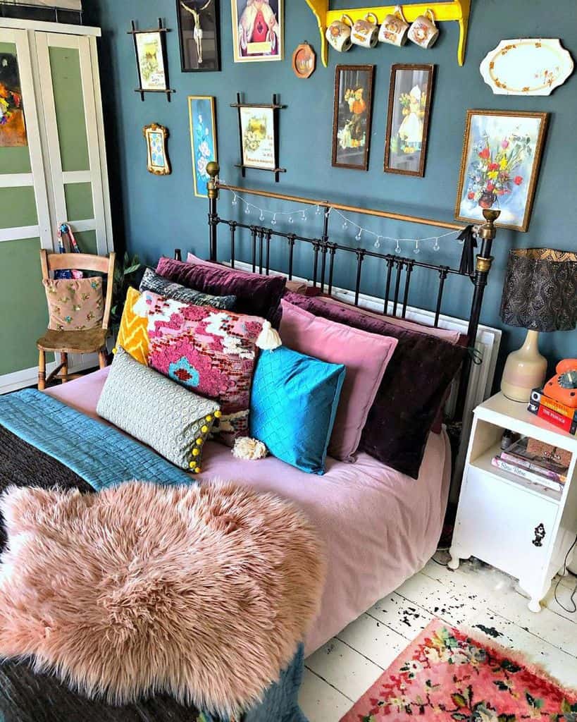 vintage style bedroom with framed wall art and cast iron bed frame