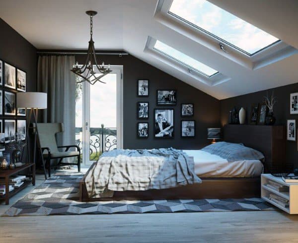 Modern attic bedroom with skylights candelabra chandelier and photo wall decor.
