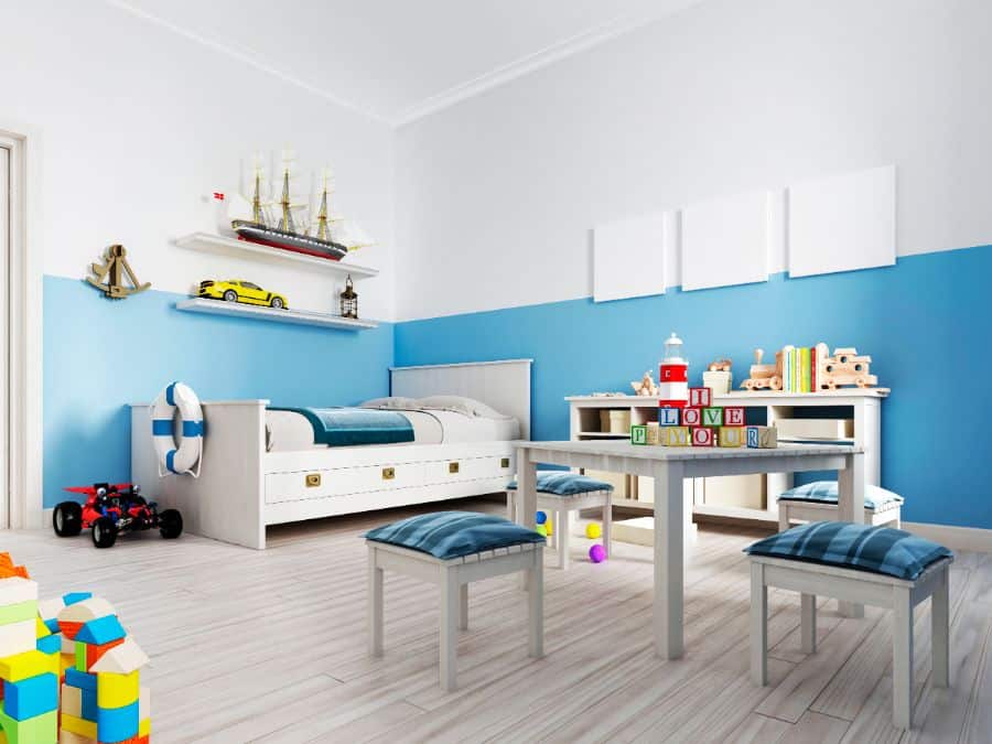 boys bedroom with blue and white walls bed table and chairs