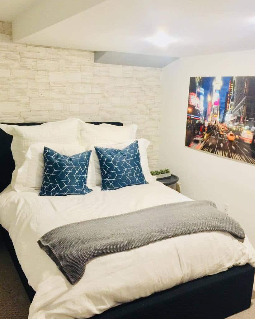white brick wall small basement bedroom