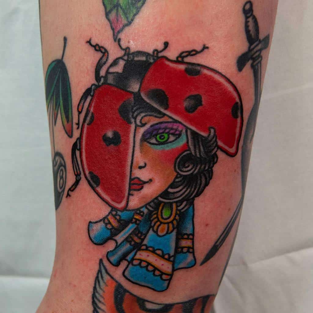 Neo-traditional tattoo of a ladybug morphing into a woman's face, blending bold colors, intricate details, and surreal artistry for a unique design.