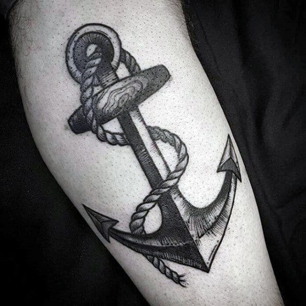 Tattoo of a shaded anchor with a rope wrapped around it on an arm