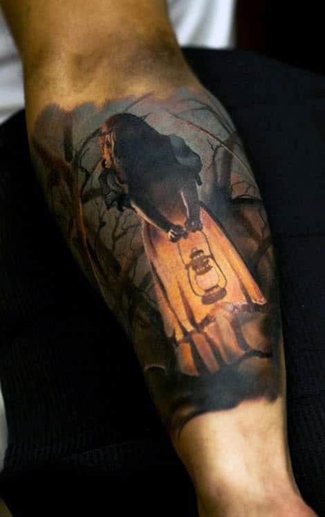 Tattoo of a figure holding a lantern in a dark, eerie forest scene on a person's arm