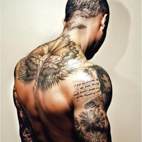 A person with detailed tattoos on their back and arms