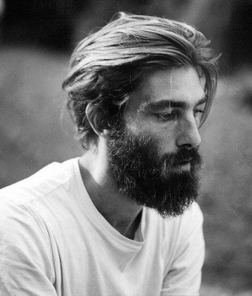 Thick, wavy hair and a full beard