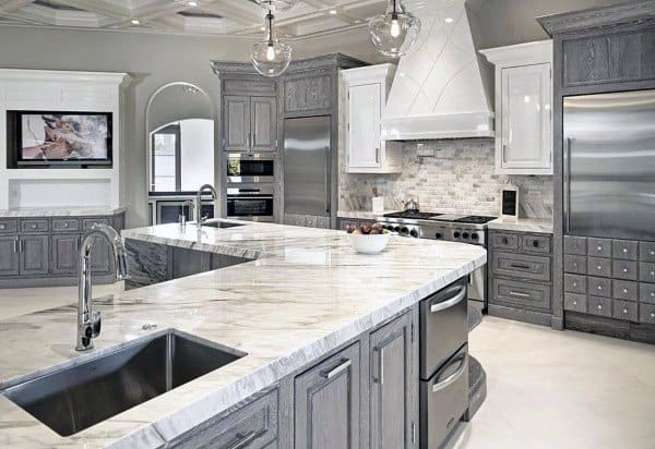 large modern kitchen with gray cabinets and marble countertops 