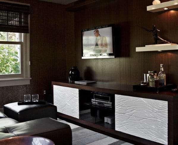 Modern man cave with TV, low cabinet, shelves, and window with blinds