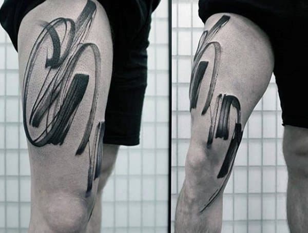 Thigh tattoo for men featuring bold abstract brushstroke-style black ink design with a modern artistic feel.