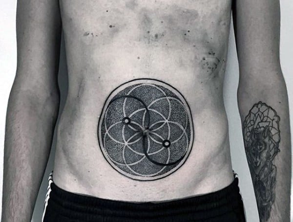 Stomach tattoo for men featuring a geometric mandala-style design with intricate dotwork and overlapping circular patterns.