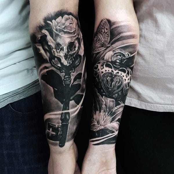 Realistic black and grey couple tattoos of a key and a heart-shaped lock, symbolizing a deep, unique bond and eternal connection.