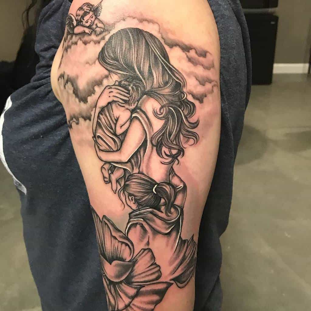 Emotional black and gray mother-daughter tattoo of a mother holding her child, with a delicate angel in the clouds above and floral details with her another daughter at the bottom