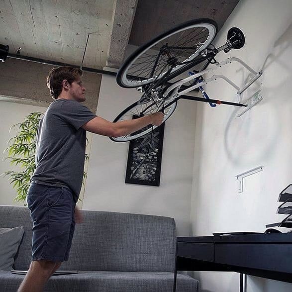 A compact garage setup with a wall-mounted rack for bike storage.