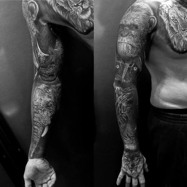 Black and grey full-sleeve tattoo featuring a lion, warrior elements, and intricate shading for a powerful and detailed design.