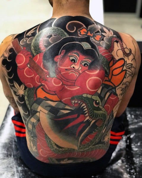 Large full-back tattoo in traditional Japanese style featuring Kintarō, the legendary boy warrior, battling a fierce green dragon with bold colors and dynamic details.
