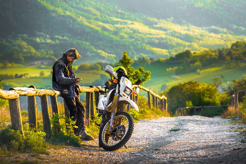 biker rest at the sunset on a wooden fence in the colli euganei