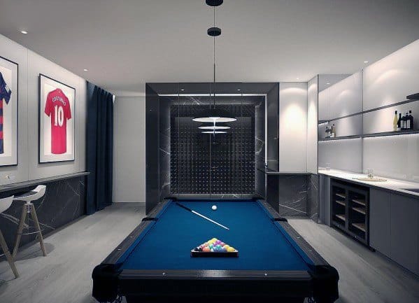 Elegant billiard room with blue felt pool table, modern lighting, and built-in bar shelving.