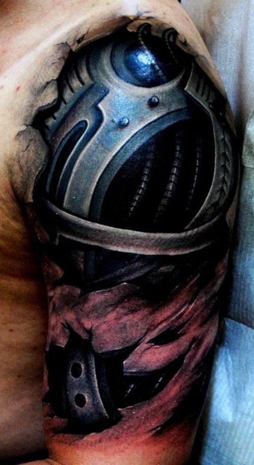 Tattoo of a medieval knight's helmet and armor on an upper arm with a torn effect