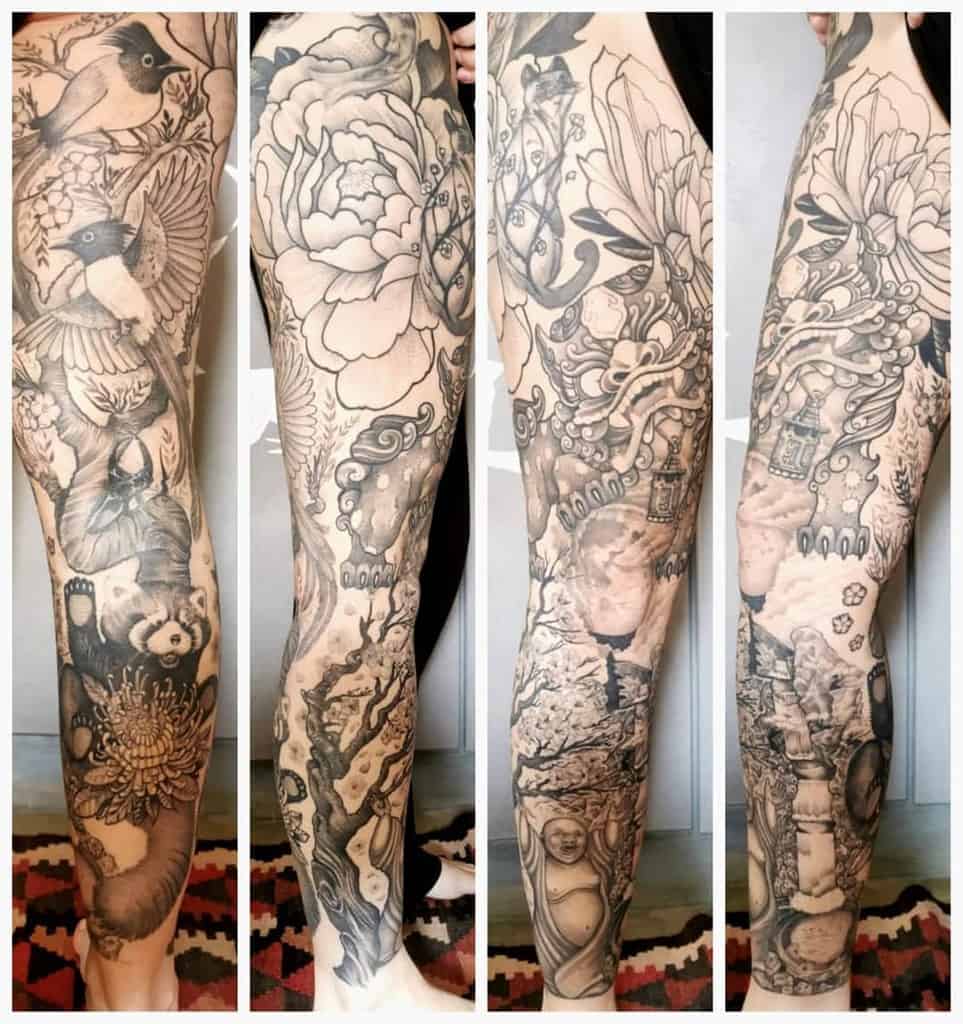 Japanese-style tattoo leg sleeve, featuring traditional elements such as birds, a panda, peonies, chrysanthemums, lanterns, dragon, sakura trees, buddha and swirling clouds
