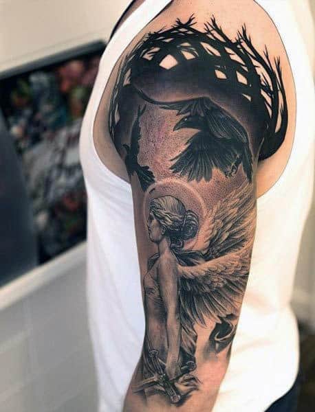 Arm tattoo of a winged woman with a sword and dark, intricate designs around her