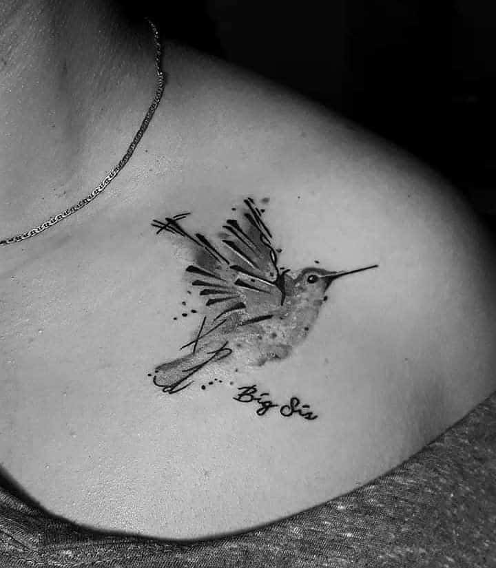 Black and grey hummingbird tattoo with artistic sketch-style wings and the words 'Big Sis' written below