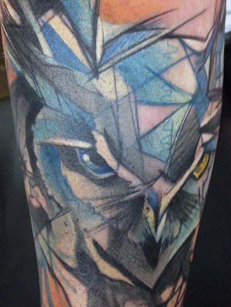 Abstract owl tattoo with geometric shapes and vibrant colors