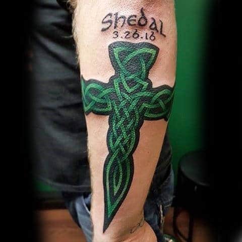 Black And Green Celtic Cross Male Outer Forearm Tattoo Designs