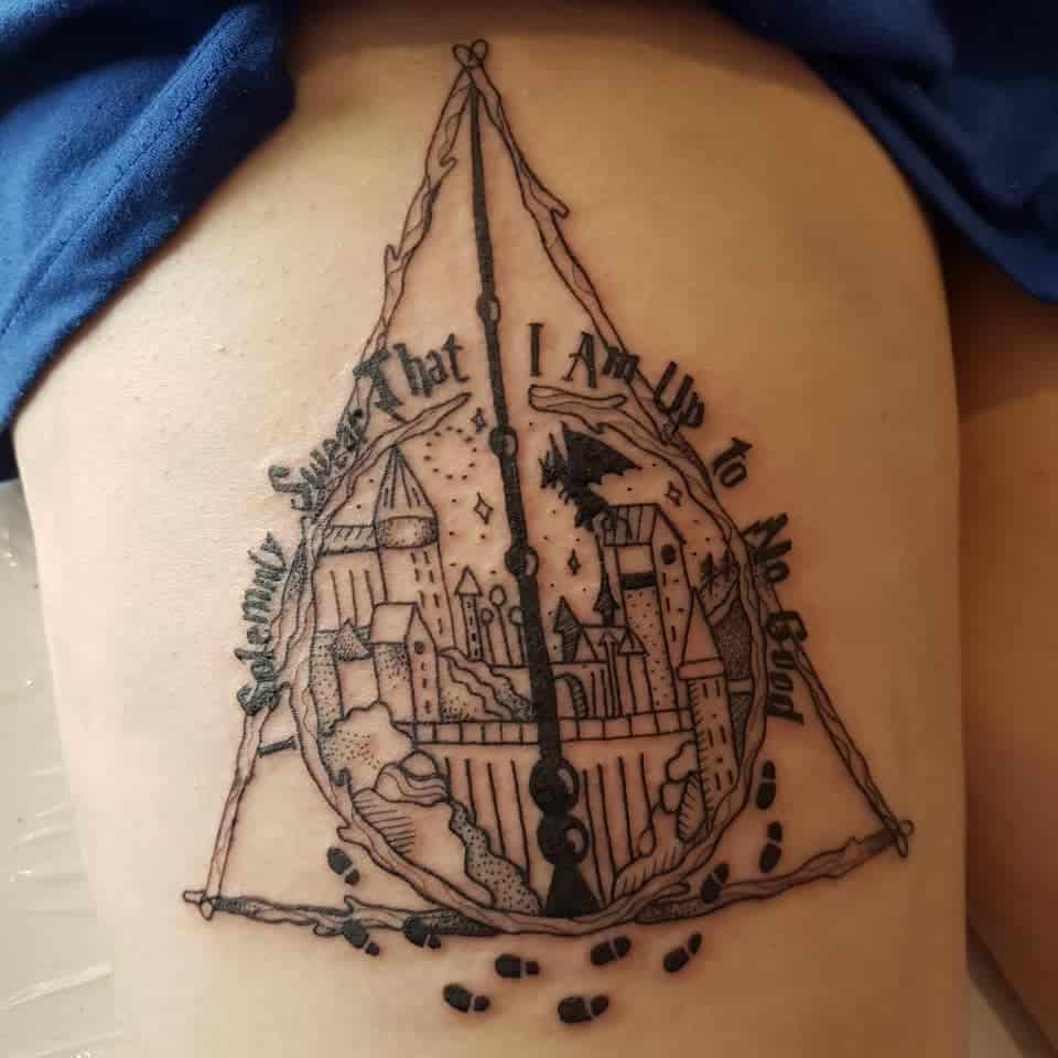 Deathly Hallows tattoo featuring Hogwarts, the Marauder’s Map footprints, and the quote 'Mischief Managed' in fine line and dotwork style.