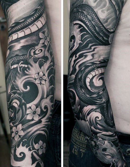 Black and grey full sleeve tattoo featuring a coiled serpent, swirling wind patterns, and delicate cherry blossoms for contrast