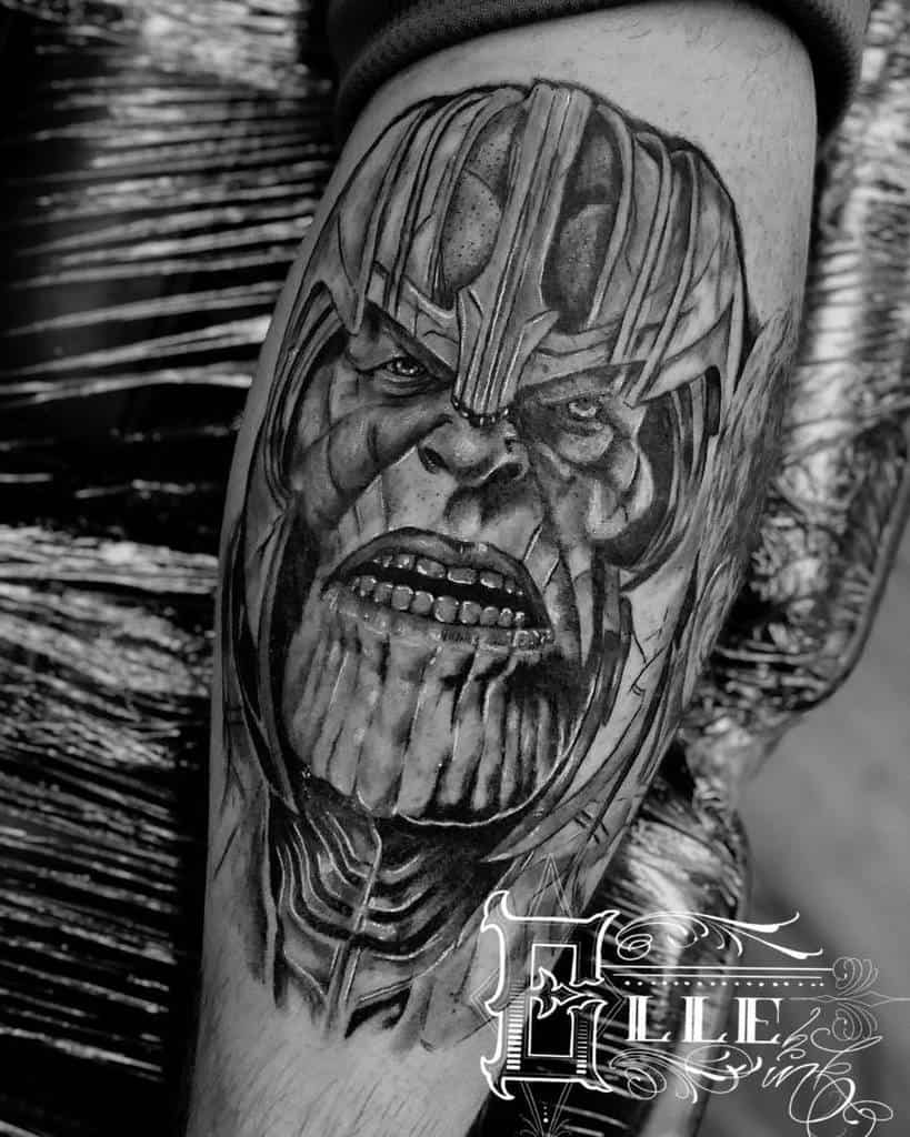 A detailed black and gray tattoo of Thanos' face, showcasing intense facial features and textures