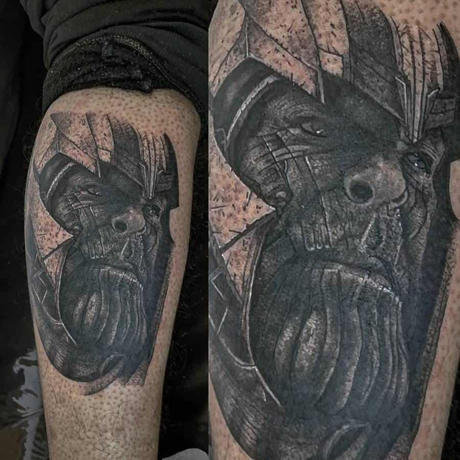 A detailed black and gray tattoo of Thanos' face with intricate shading and sharp, angular lines that highlight his features