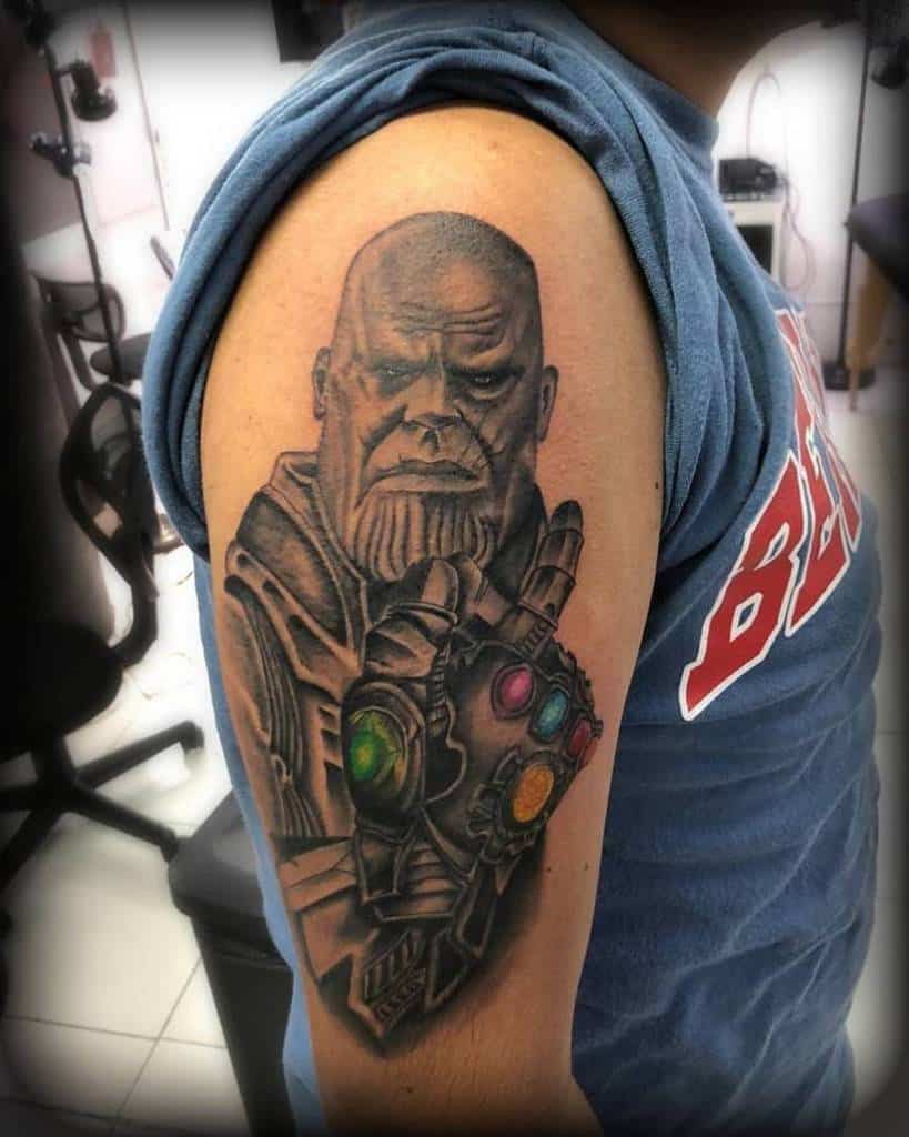 A colorful tattoo of Thanos' face and gauntlet, featuring the Infinity Stones and showcasing his intense expression with detailed shading